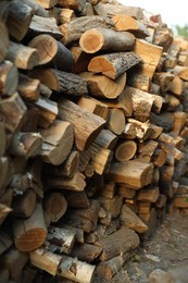 Photo of Pile of cut firewood outdoors, closeup view