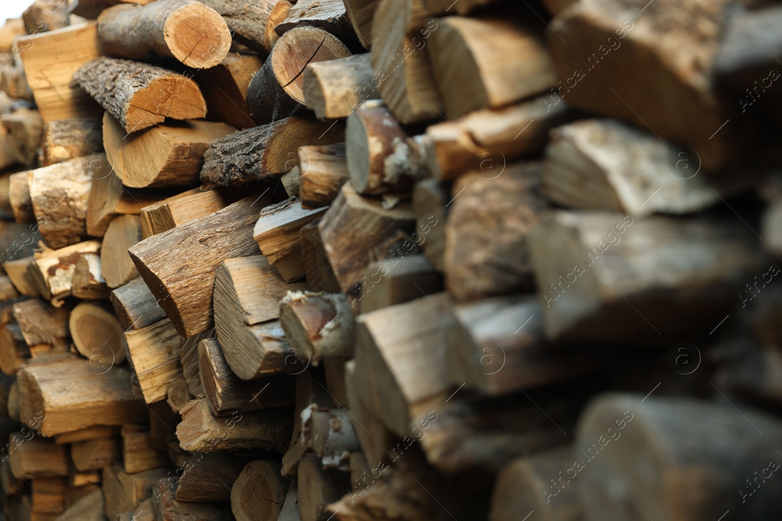 Photo of Pile of cut firewood outdoors, closeup view