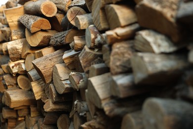Photo of Pile of cut firewood outdoors, closeup view