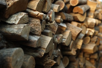 Photo of Pile of cut firewood outdoors, closeup view
