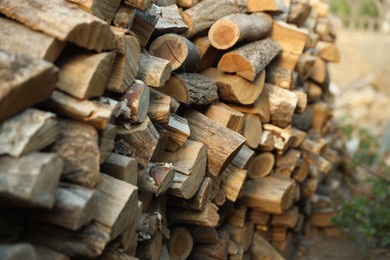 Photo of Pile of cut firewood outdoors, closeup view