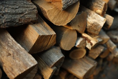 Photo of Pile of cut firewood outdoors, closeup view
