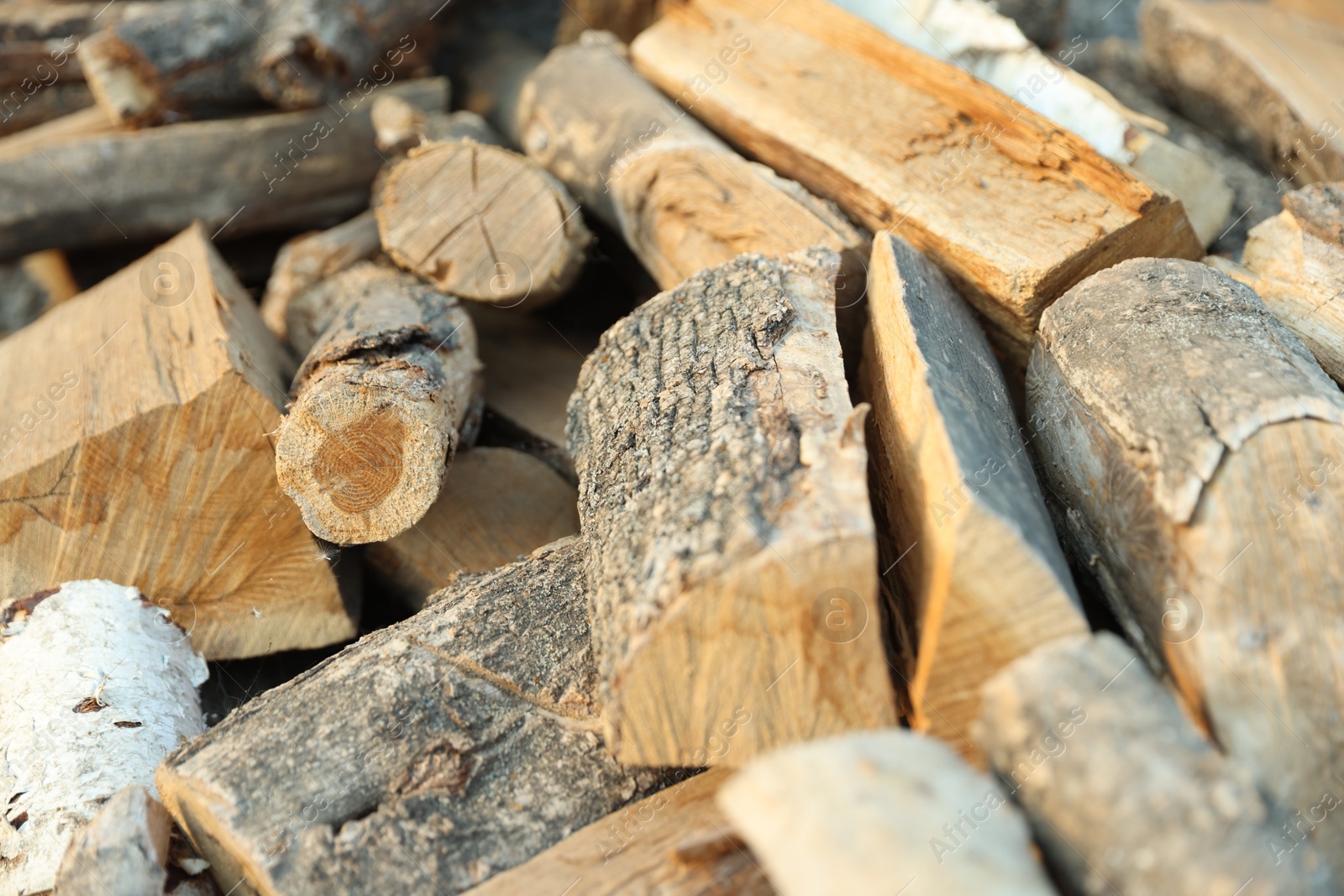 Photo of Pile of cut firewood outdoors, closeup view