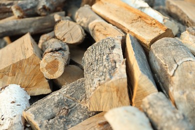 Photo of Pile of cut firewood outdoors, closeup view