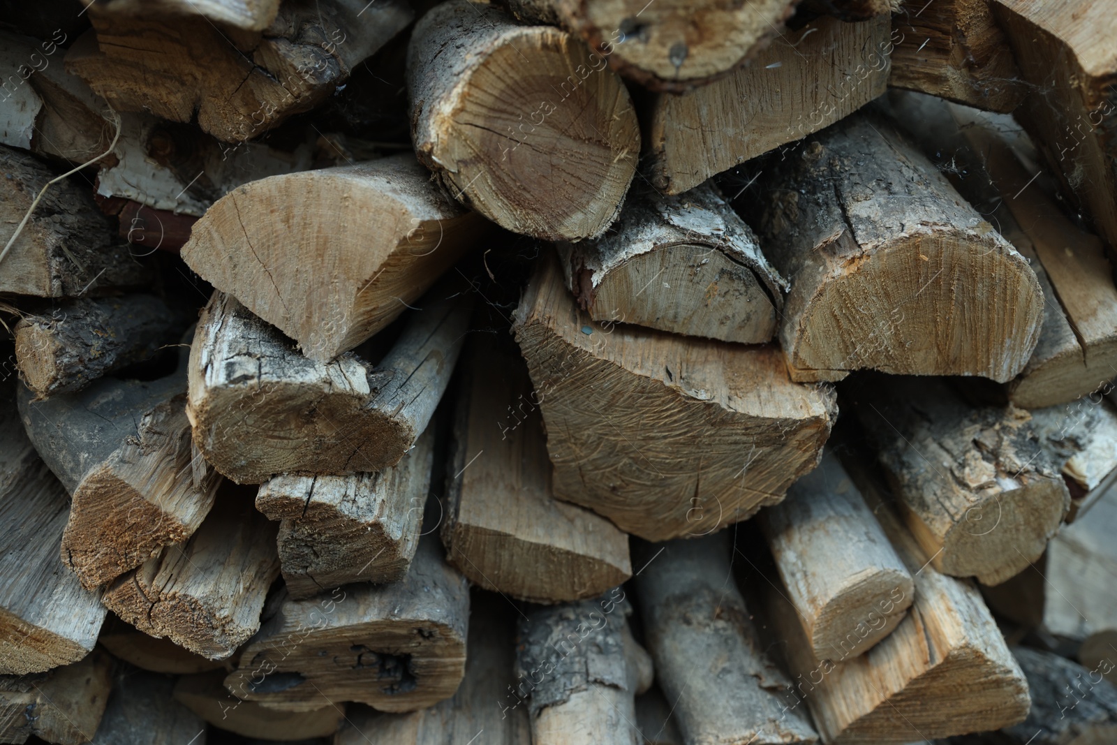 Photo of Pile of cut firewood outdoors, closeup view