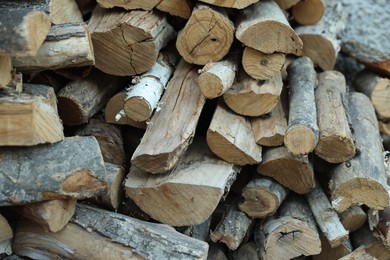 Photo of Pile of cut firewood outdoors, closeup view
