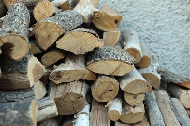 Photo of Pile of cut firewood outdoors, closeup view
