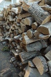 Photo of Pile of cut firewood outdoors, closeup view