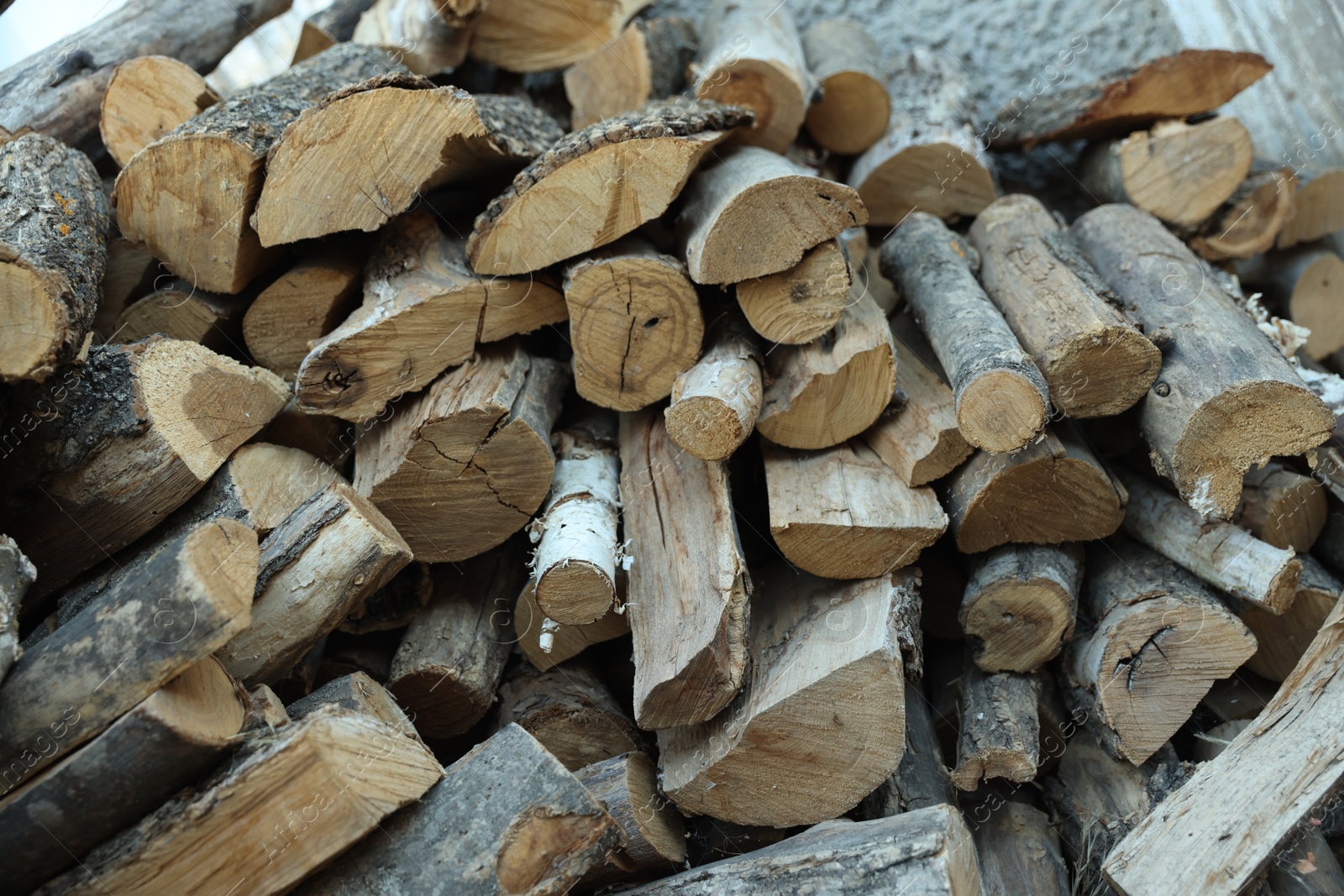 Photo of Pile of cut firewood outdoors, closeup view
