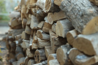 Photo of Pile of cut firewood outdoors, closeup view