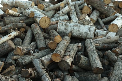 Photo of Pile of cut firewood outdoors, closeup view