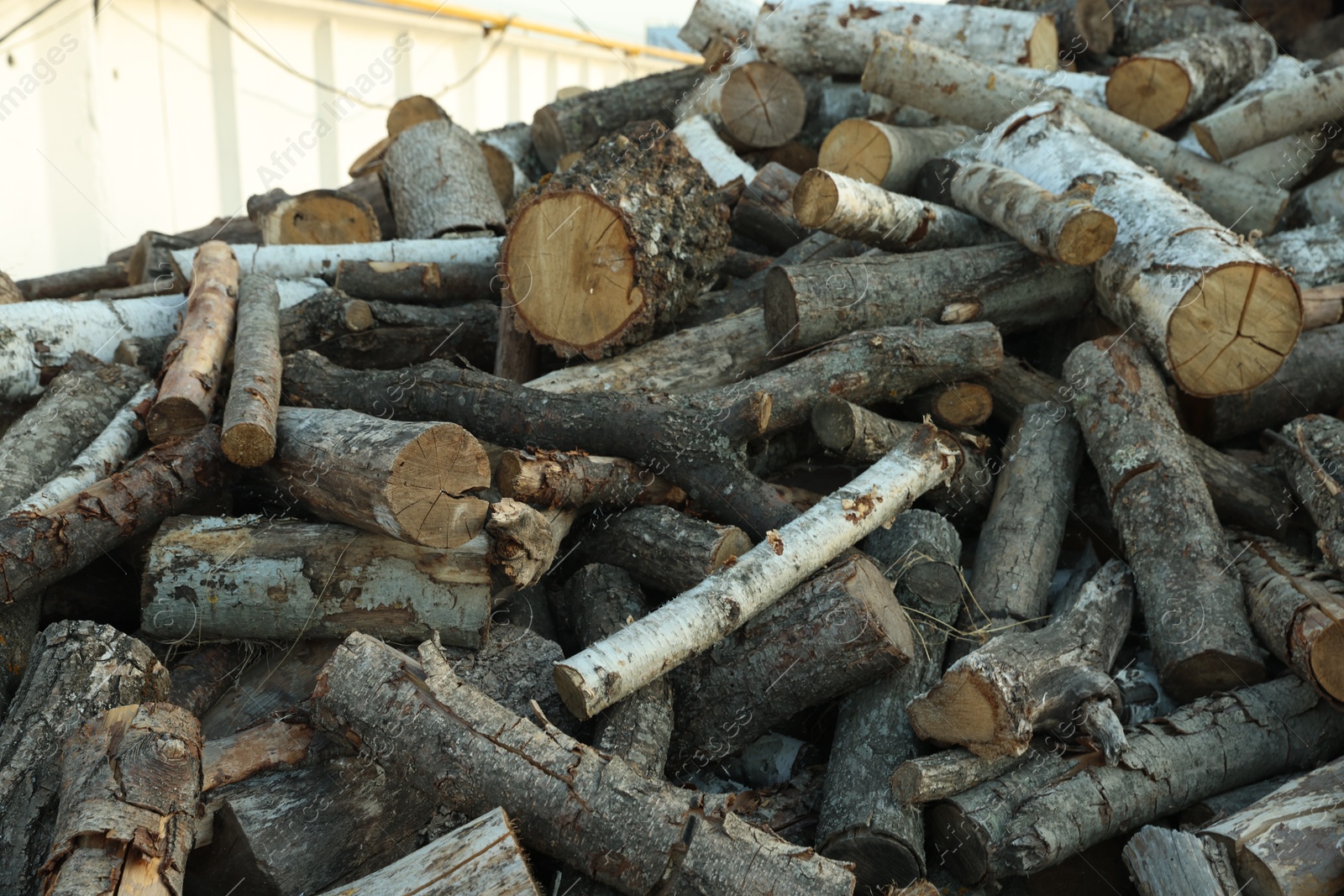 Photo of Pile of cut firewood outdoors, closeup view