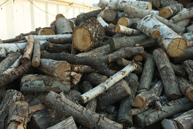 Photo of Pile of cut firewood outdoors, closeup view