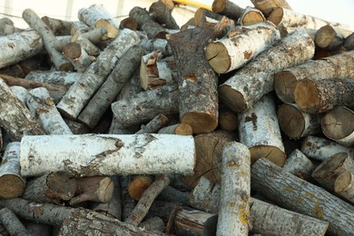 Photo of Pile of cut firewood outdoors, closeup view