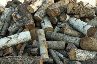 Photo of Pile of cut firewood outdoors, closeup view