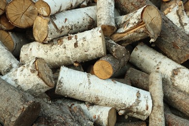 Photo of Pile of cut firewood outdoors, closeup view
