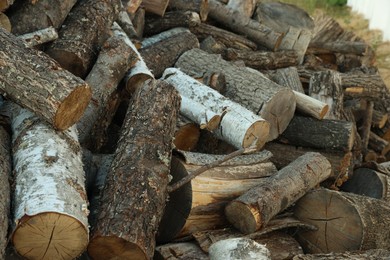 Photo of Pile of cut firewood outdoors, closeup view