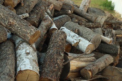 Photo of Pile of cut firewood outdoors, closeup view
