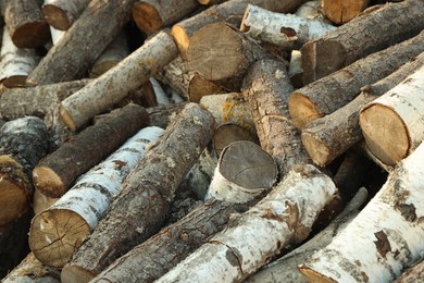 Photo of Pile of cut firewood outdoors, closeup view