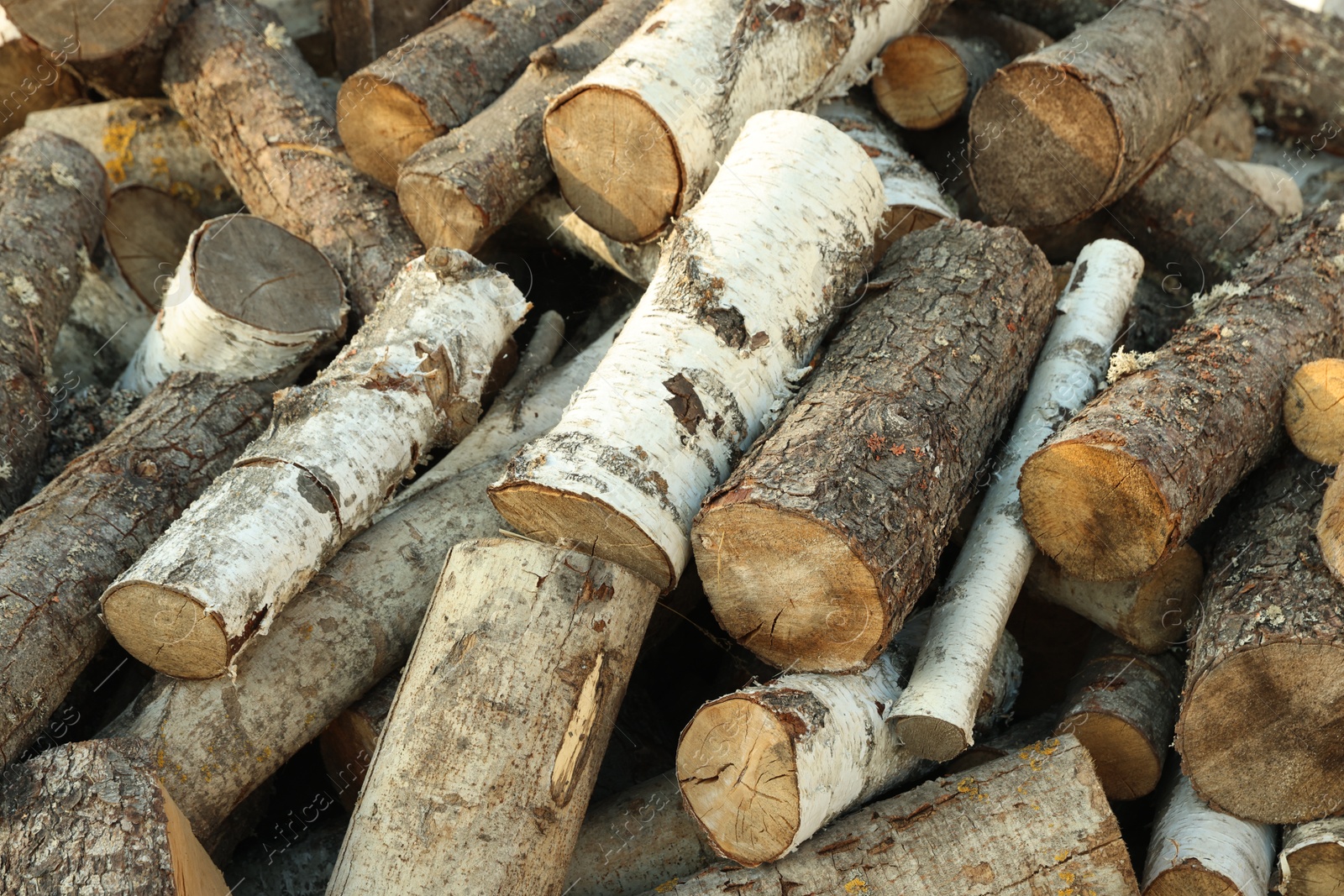 Photo of Pile of cut firewood outdoors, closeup view