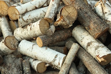 Photo of Pile of cut firewood outdoors, closeup view