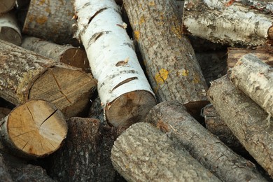 Photo of Pile of cut firewood outdoors, closeup view