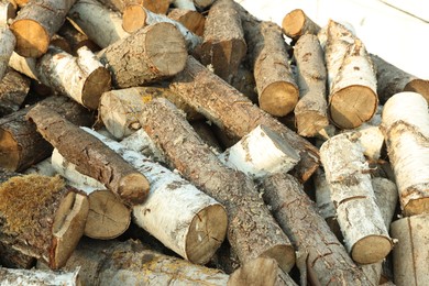 Photo of Pile of cut firewood outdoors, closeup view