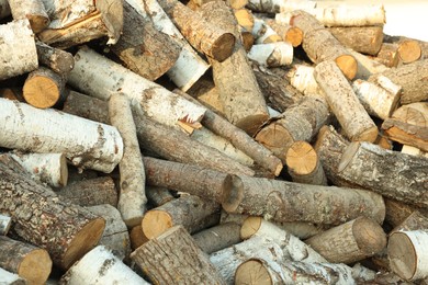 Photo of Pile of cut firewood outdoors, closeup view