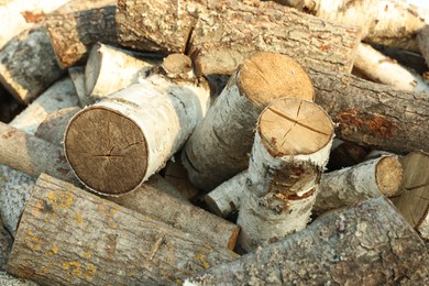Photo of Pile of cut firewood outdoors, closeup view