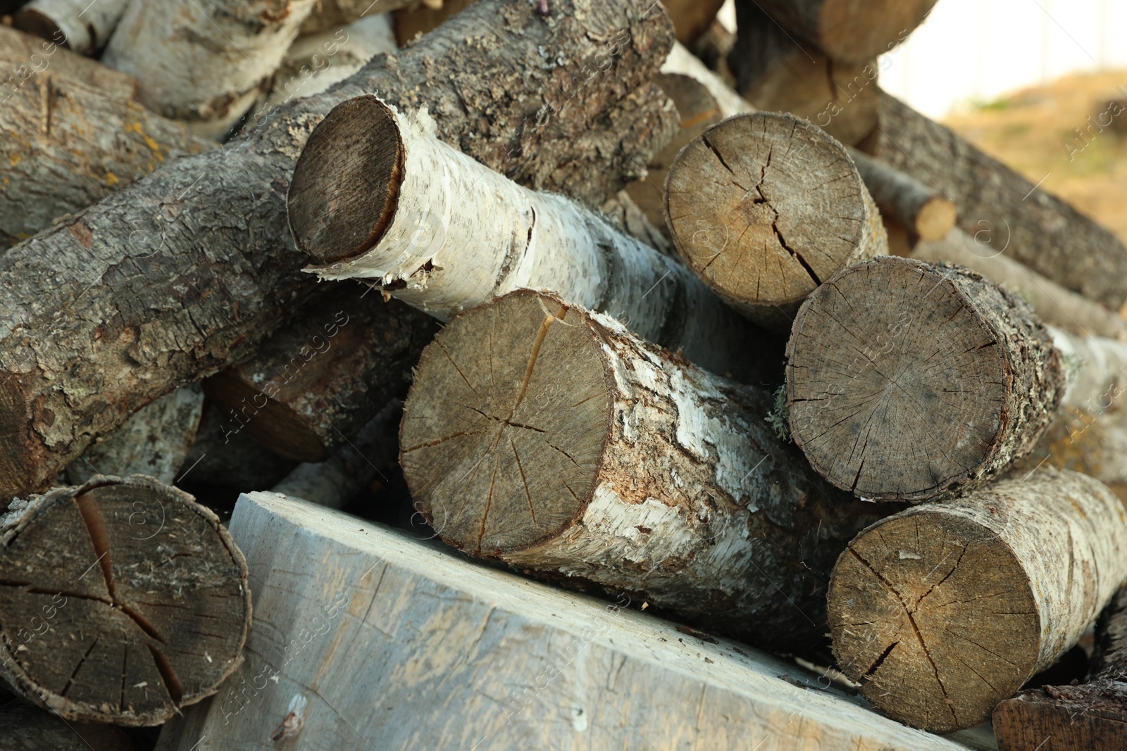 Photo of Pile of cut firewood outdoors, closeup view