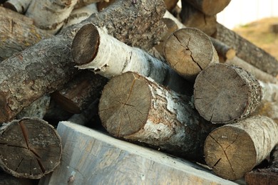 Photo of Pile of cut firewood outdoors, closeup view