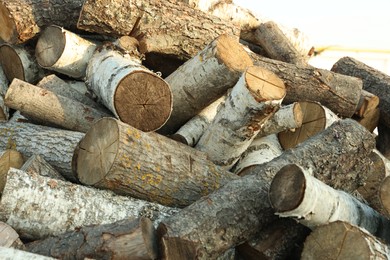 Photo of Pile of cut firewood outdoors, closeup view