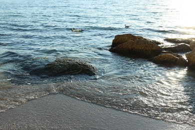 Photo of Beautiful wavy sea and stones on sunny day