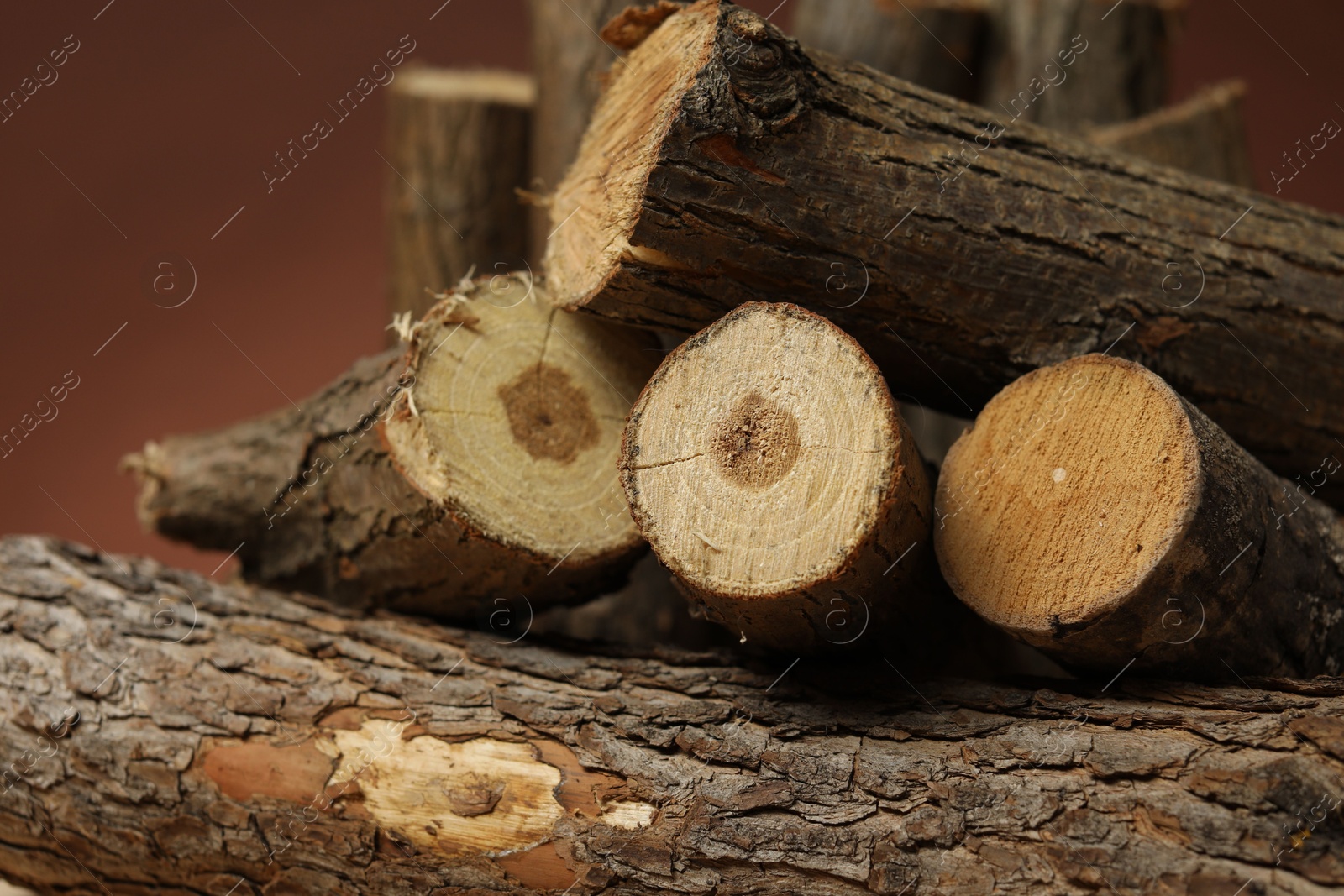 Pile of cut firewood on brown background, closeup Photo of Pile of cut firewood on brown background, closeup