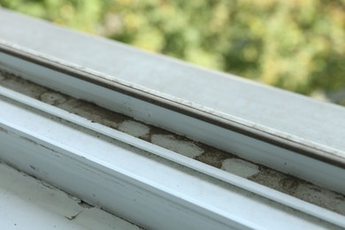 Photo of Window frame covered with dust indoors, closeup