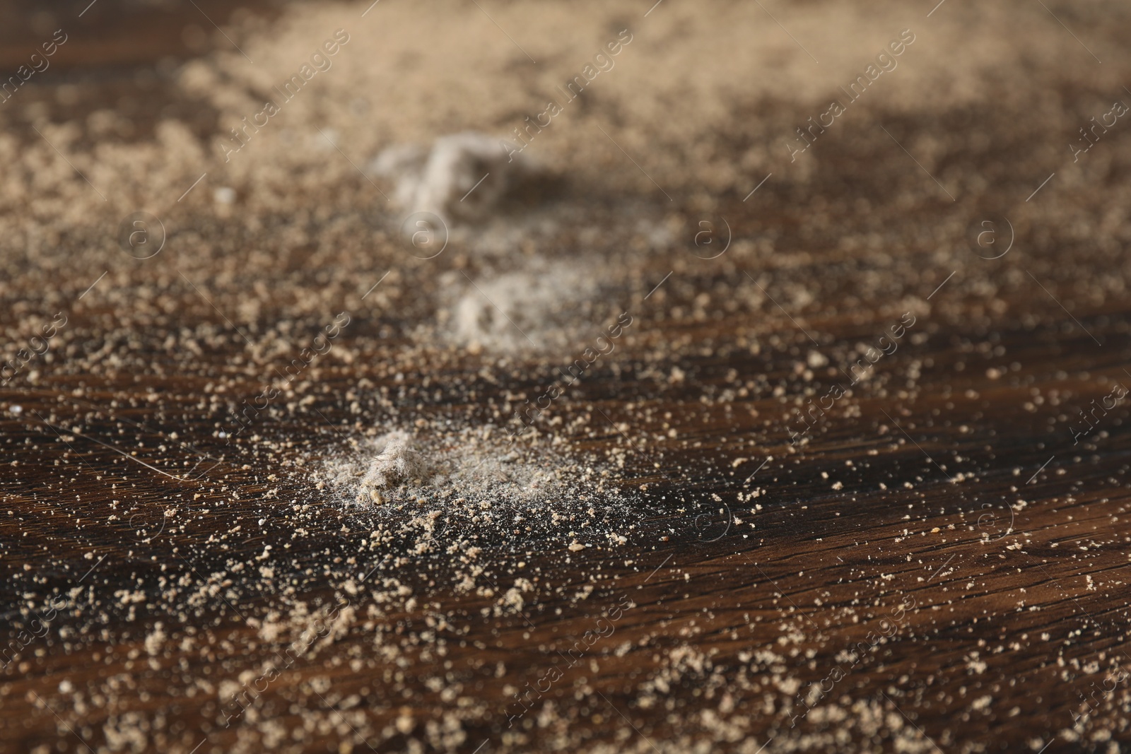 Photo of Wooden table covered with dust, closeup view