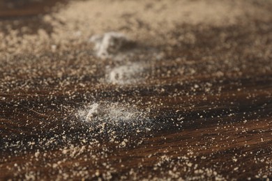 Photo of Wooden table covered with dust, closeup view