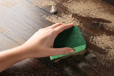 Photo of Woman wiping dust off wooden table, above view