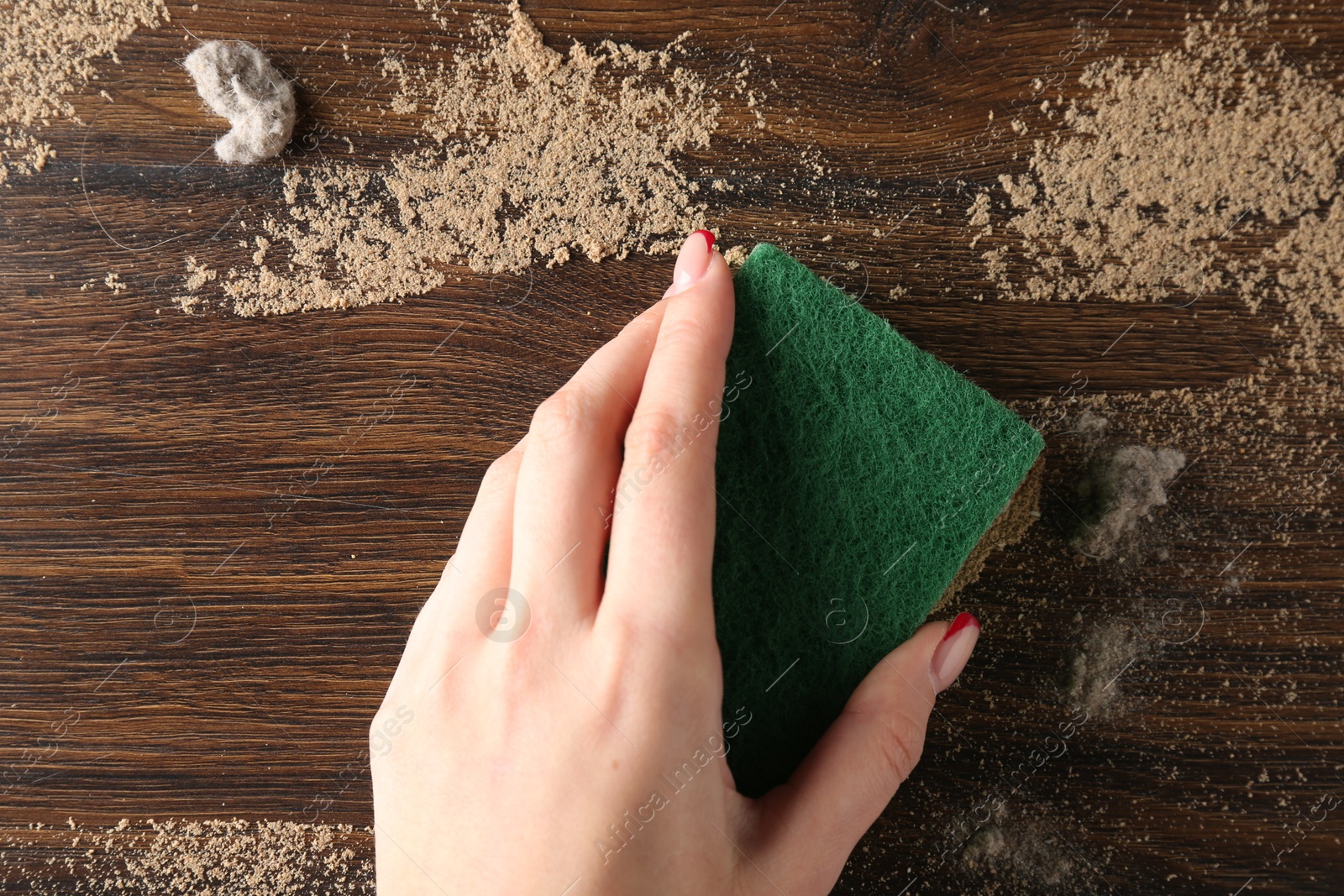 Woman wiping dust off wooden table, top view Photo of Woman wiping dust off wooden table, top view