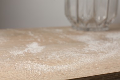 Photo of Wooden table covered with dust indoors, closeup