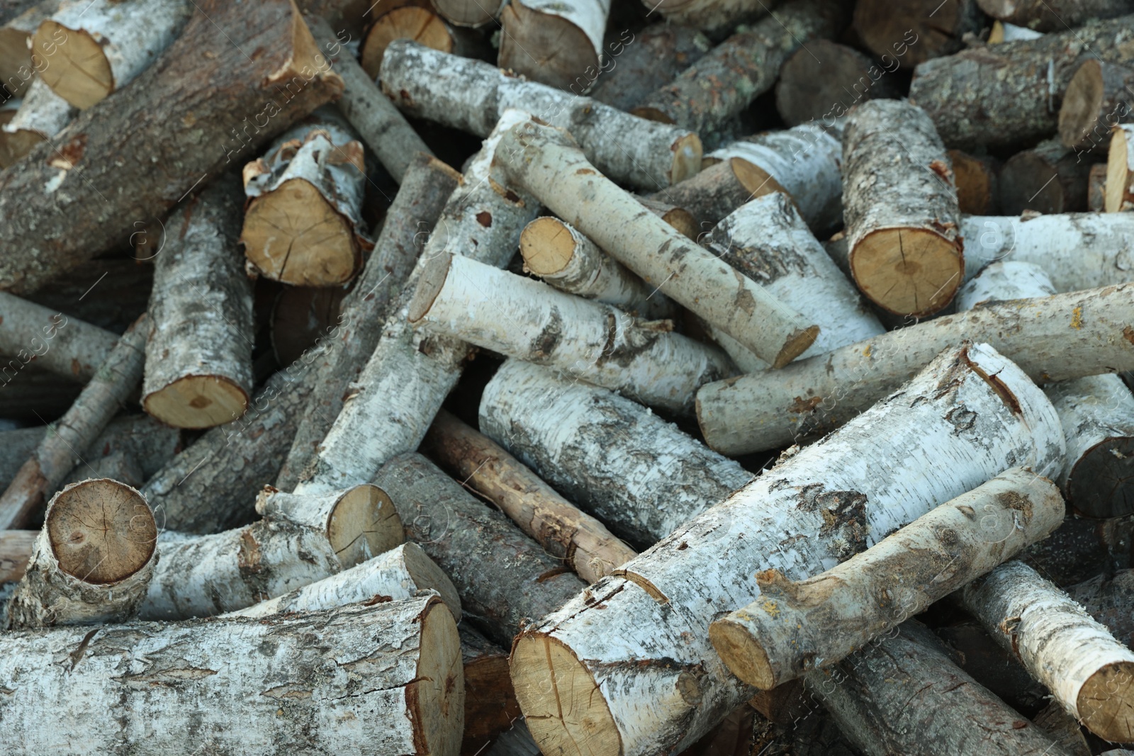 Photo of Pile of cut firewood outdoors, closeup view