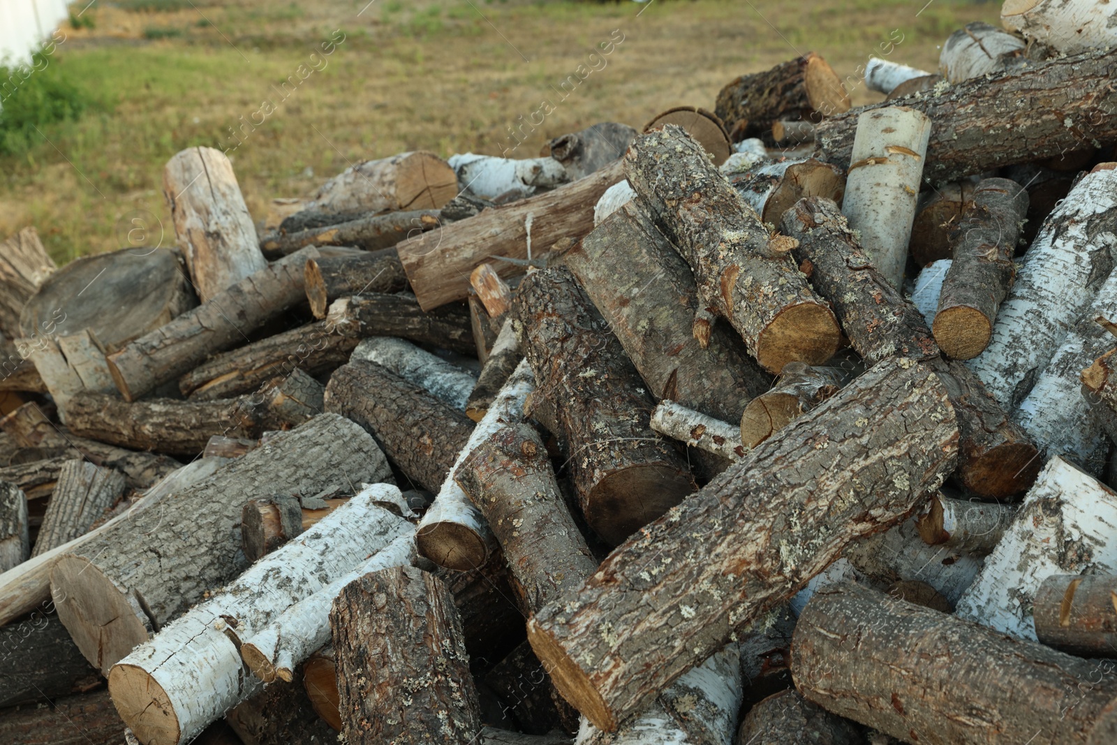 Pile of cut firewood outdoors, closeup view Photo of Pile of cut firewood outdoors, closeup view