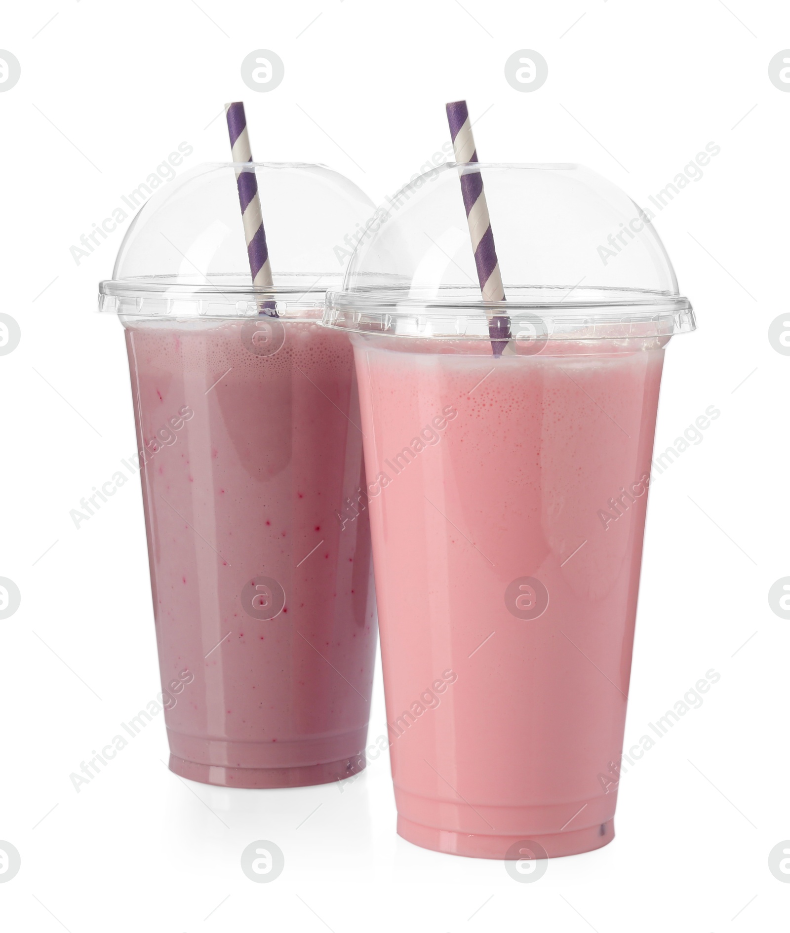 Photo of Milkshakes of different flavors in plastic cups isolated on white