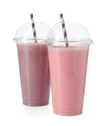 Photo of Milkshakes of different flavors in plastic cups isolated on white