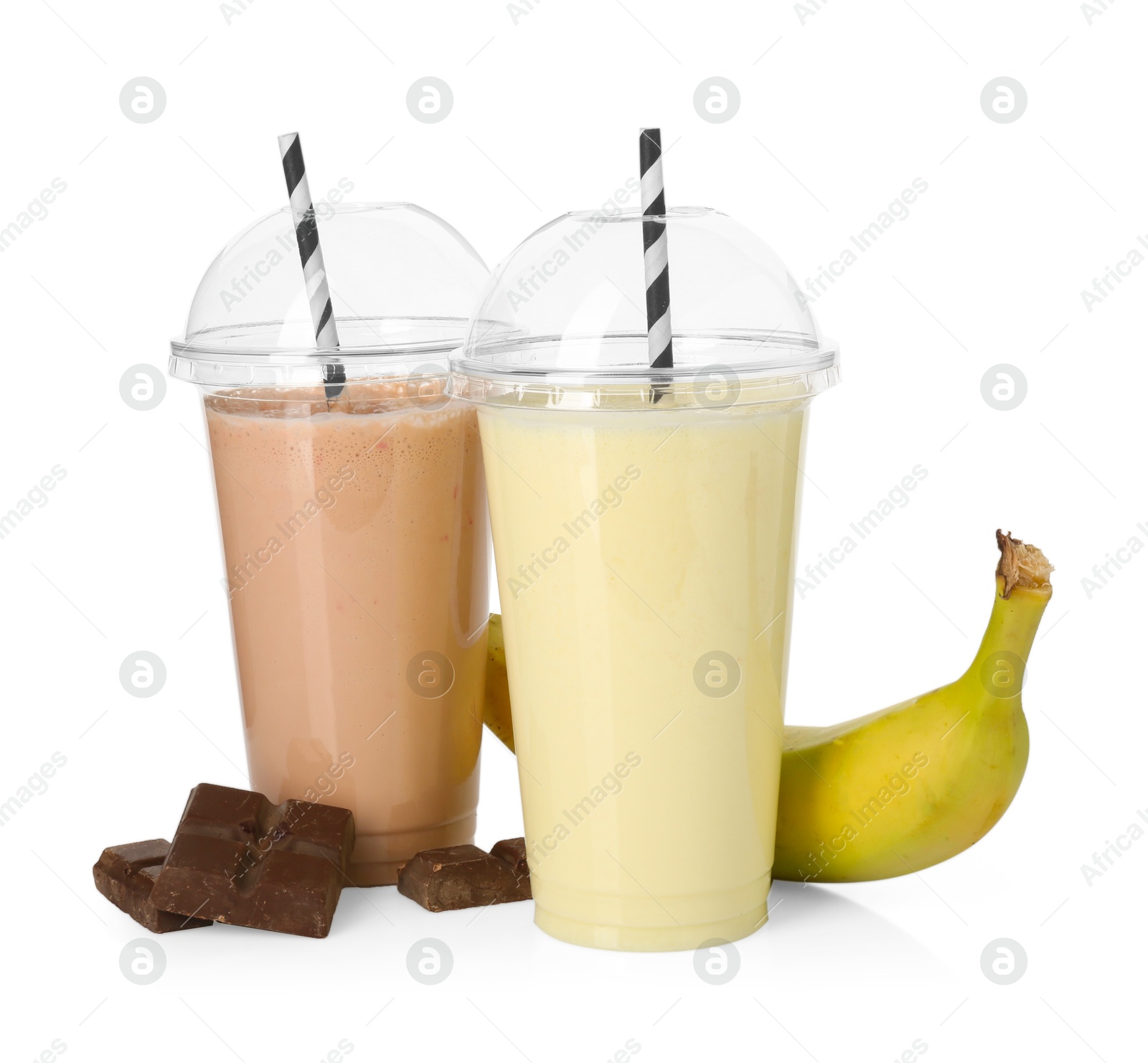 Photo of Milkshakes of different flavors in plastic cups and ingredients isolated on white