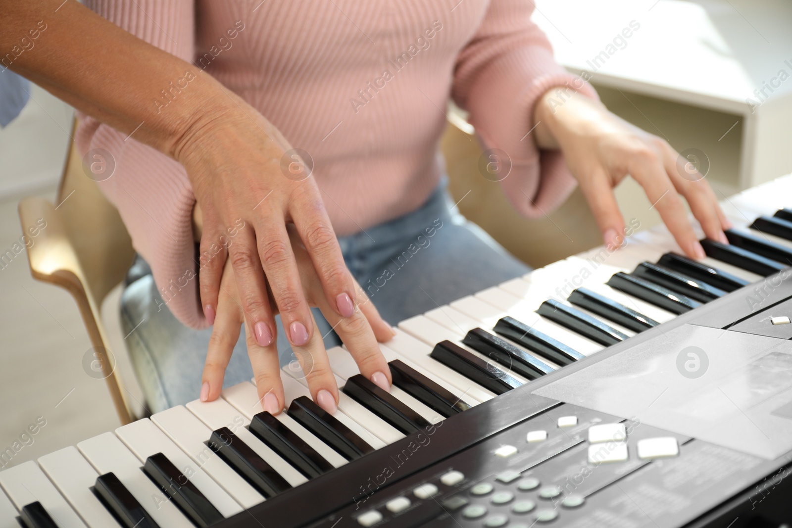 Tutor teaching woman to play piano indoors, closeup Photo of Tutor teaching woman to play piano indoors, closeup