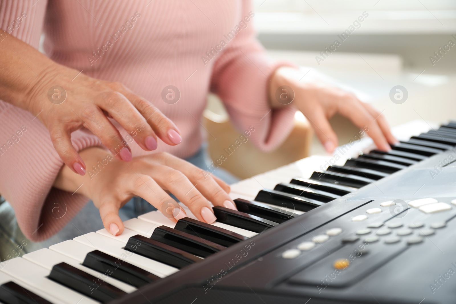 Tutor teaching woman to play piano indoors, closeup Photo of Tutor teaching woman to play piano indoors, closeup