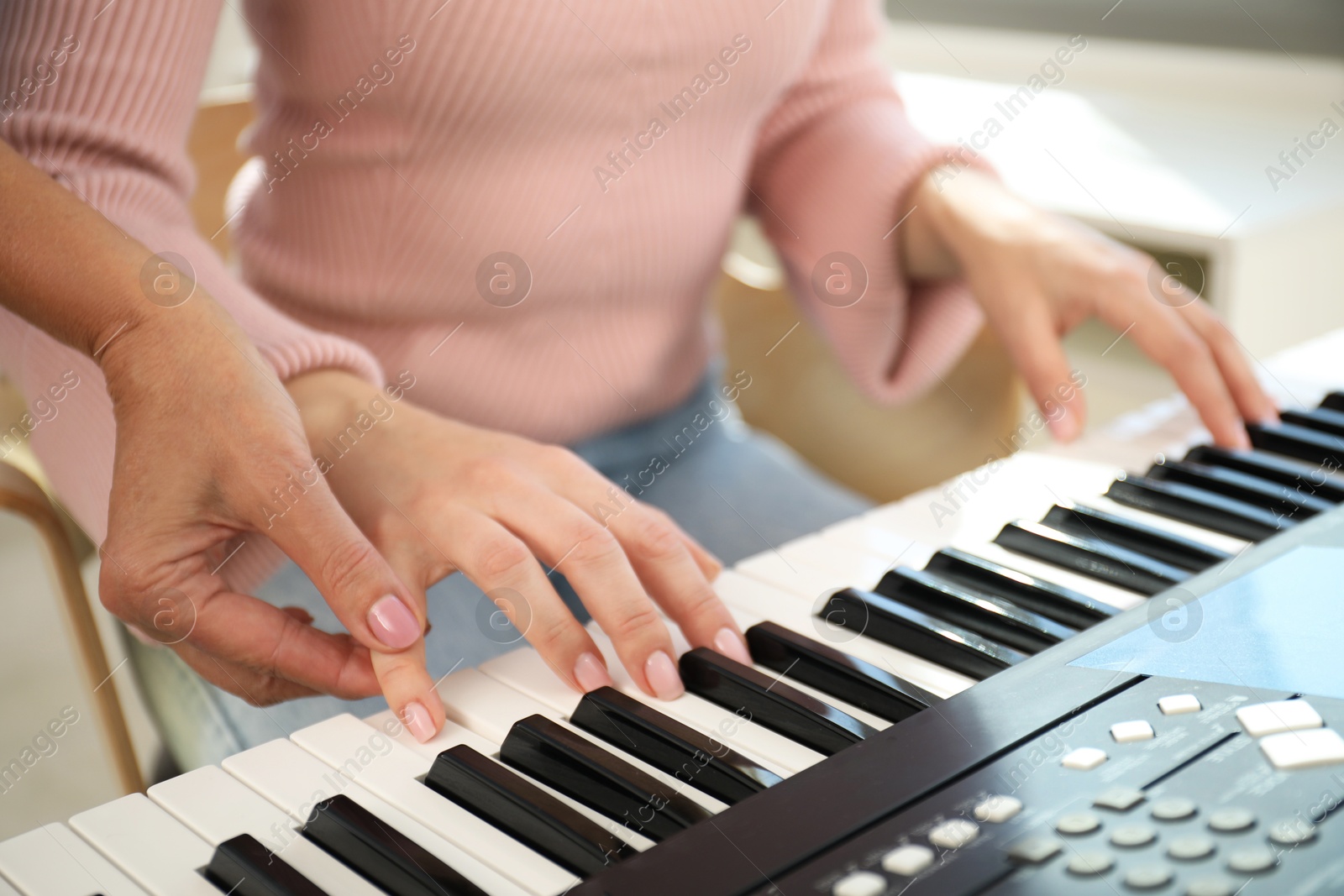Tutor teaching woman to play piano indoors, closeup Photo of Tutor teaching woman to play piano indoors, closeup