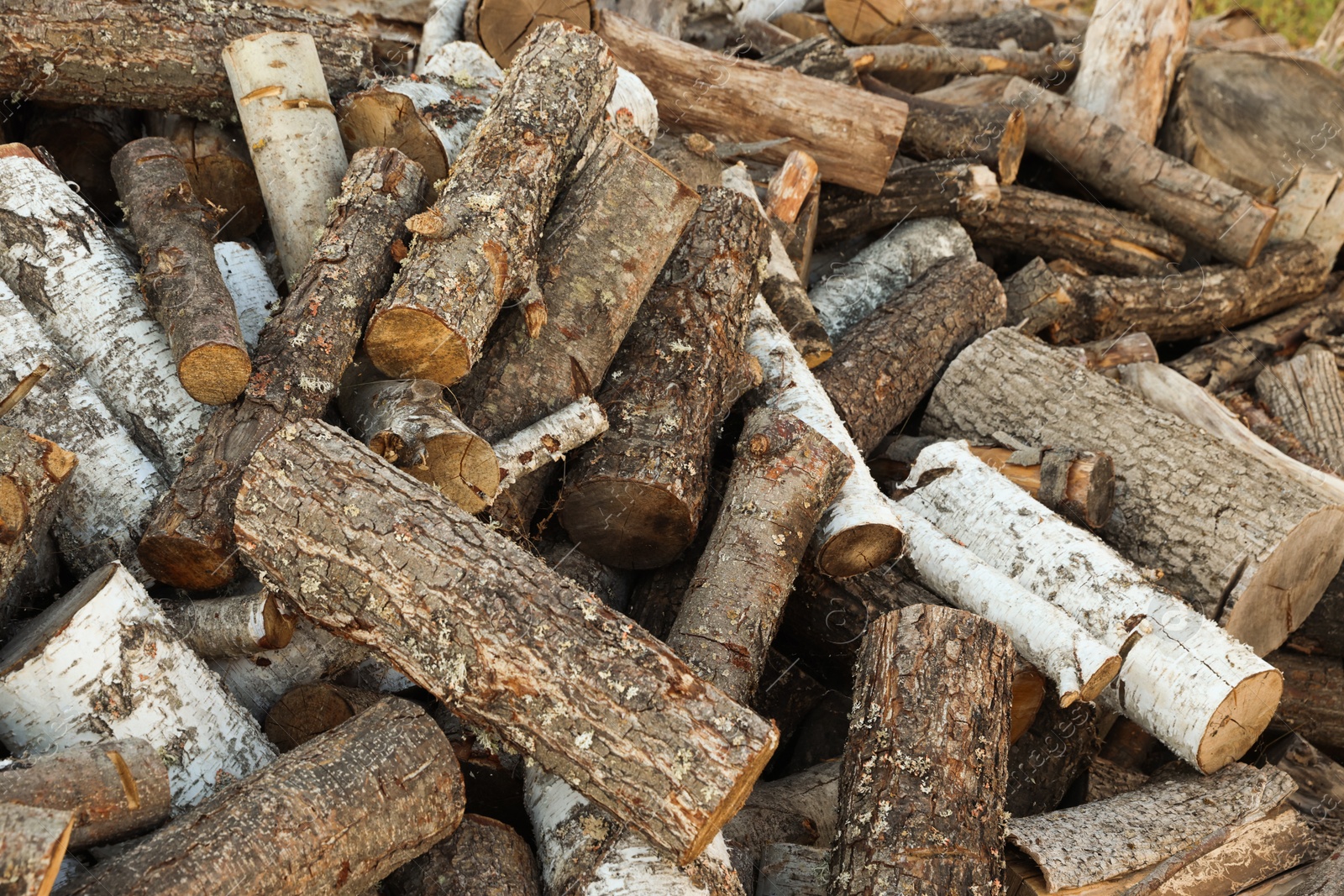 Photo of Pile of cut firewood outdoors, closeup view