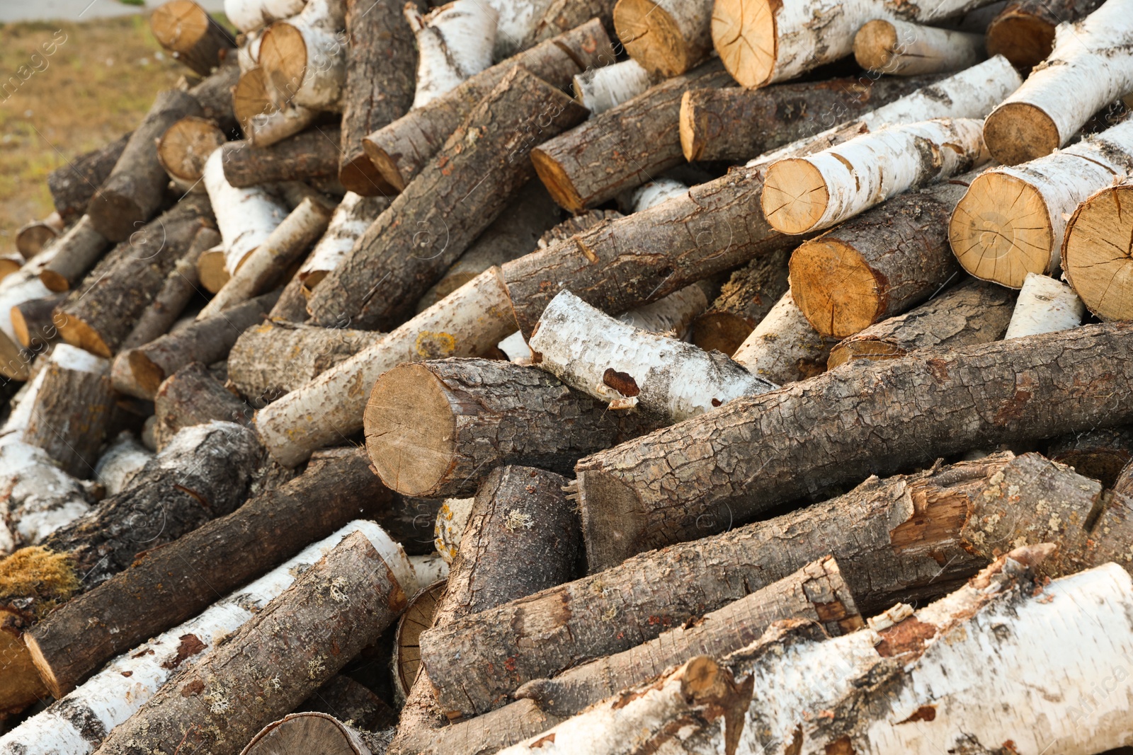 Photo of Pile of cut firewood outdoors, closeup view